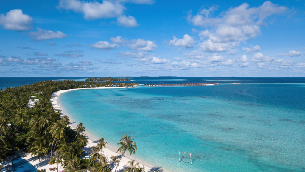 Kandima Island surrounded by turquoise lagoon and coral reef in Dhaalu Atoll Maldives