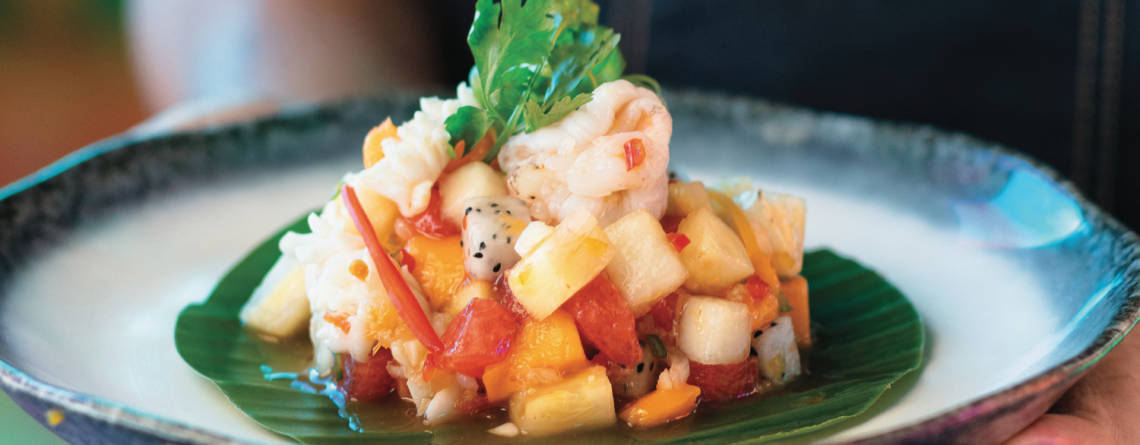 Chef presenting a colourful island-inspired dish at Kandima Maldives in Dhaalu Atoll.